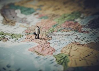 Macro photos of a figurine standing on a map of Europe