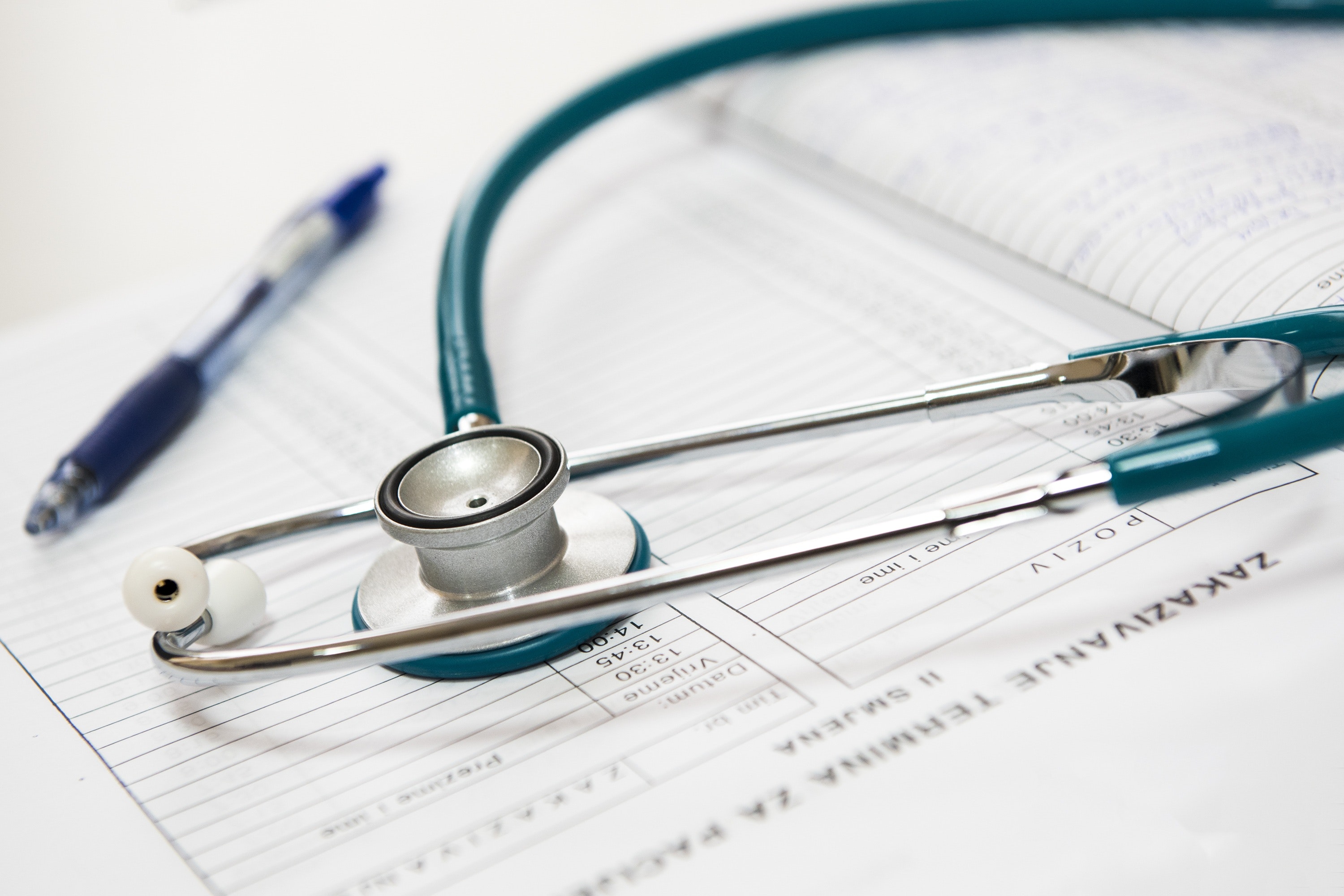 Close up image of a stethoscope over doctor's notes