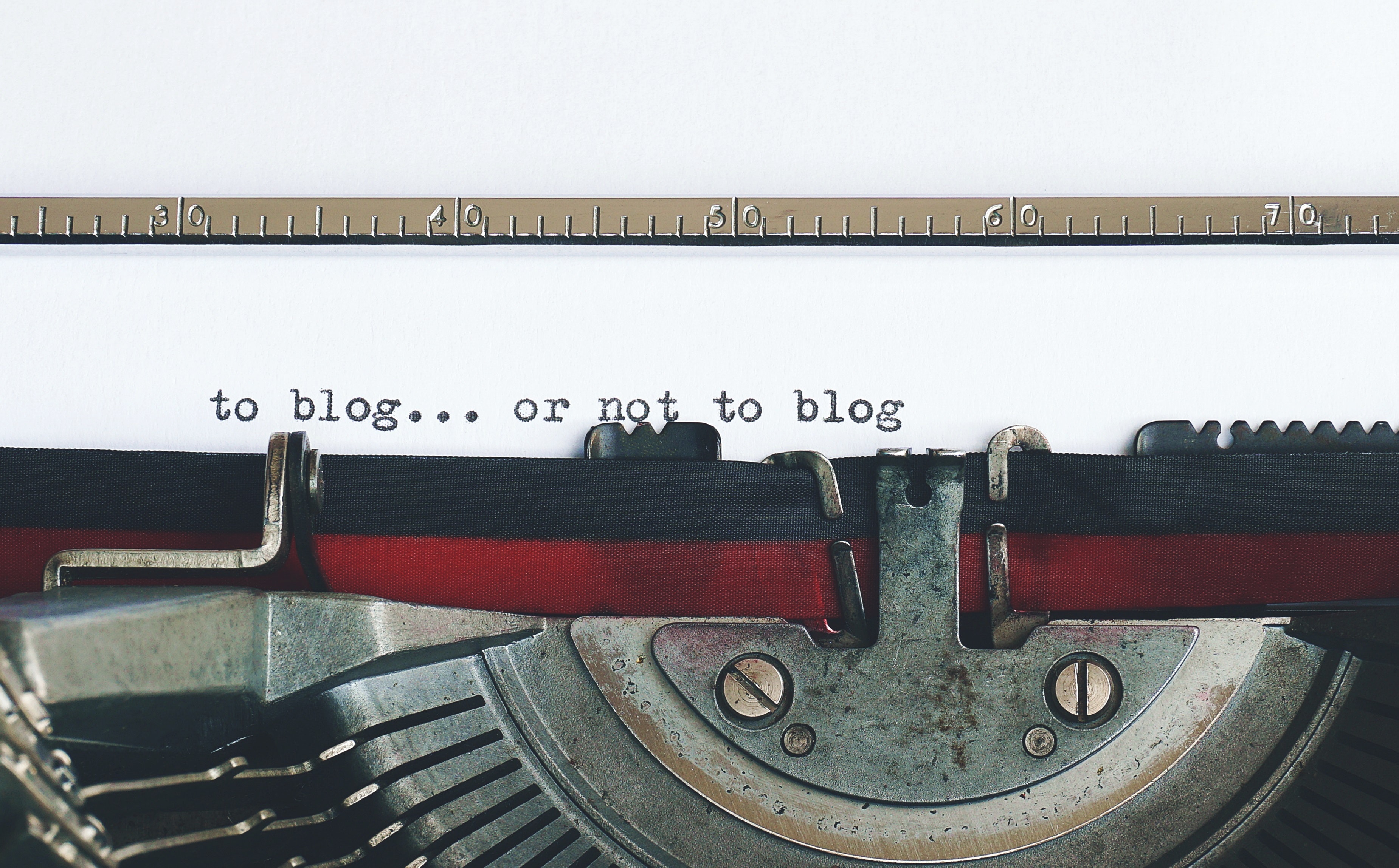 Vintage typewriter types out "to blog...or not to blog..."