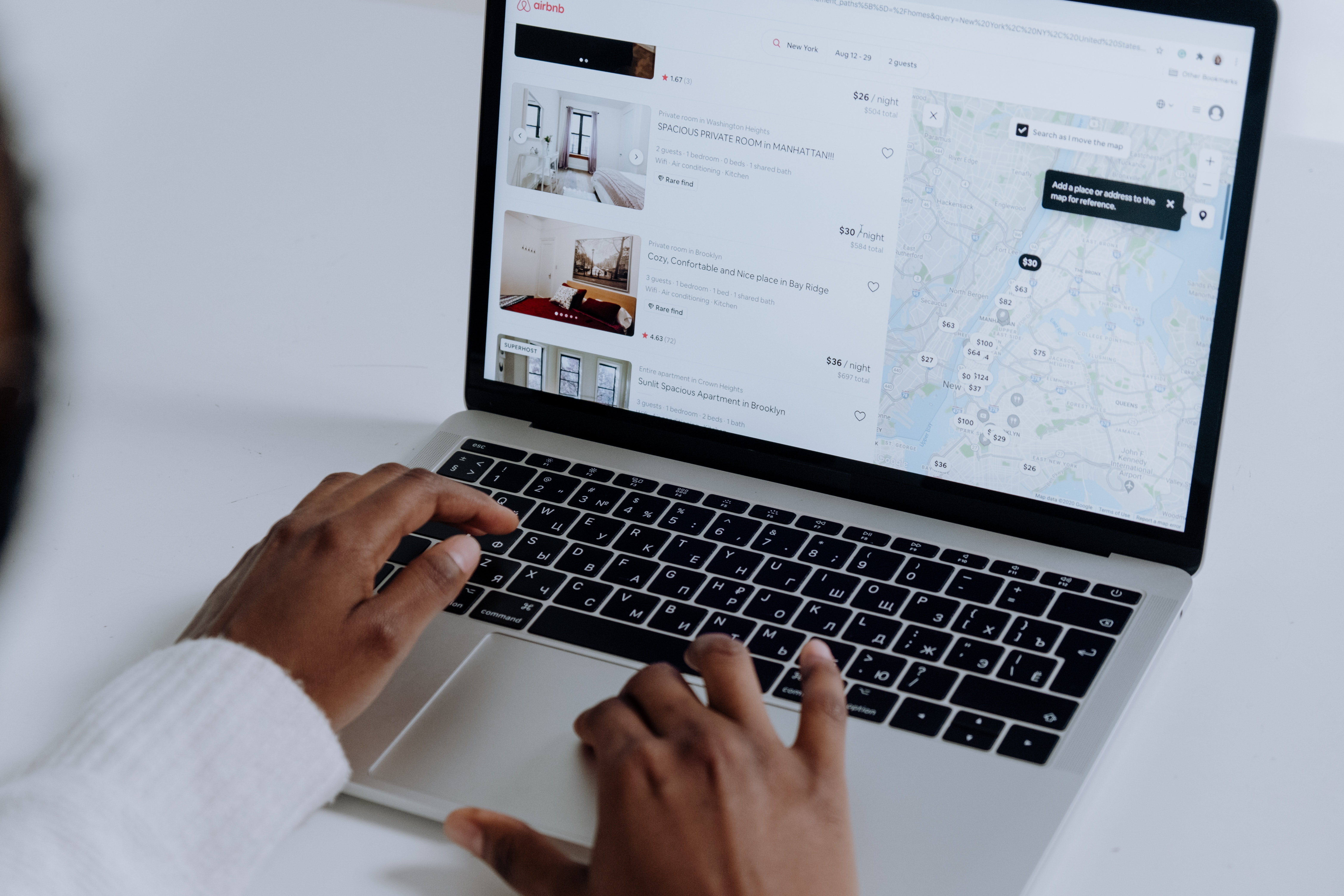 Person browses local map on laptop