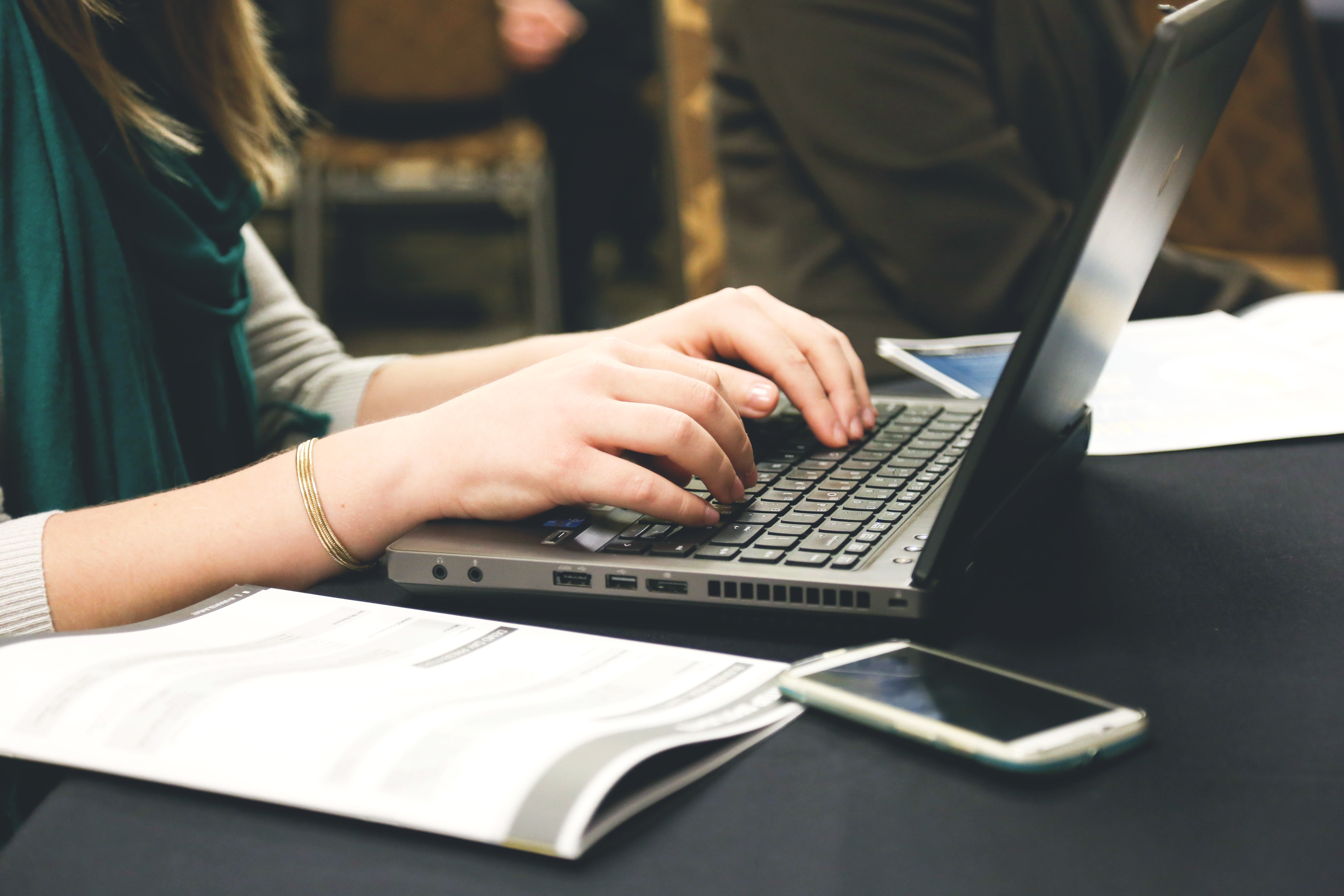 Close up of a person typing o their laptop