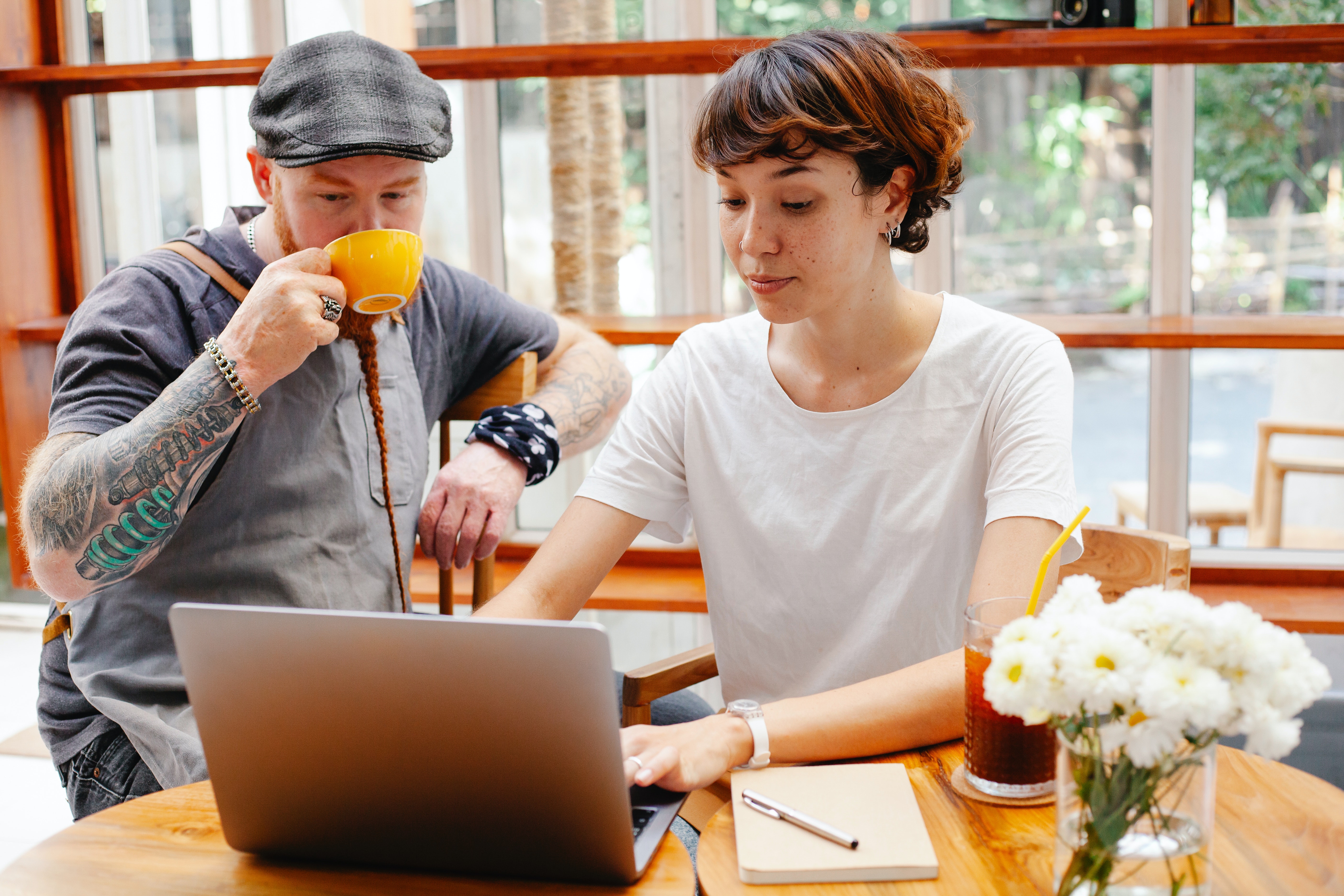 Two young business owners meet in a. coffee shop for a strategy meeting