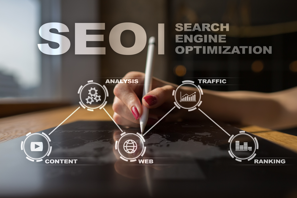 Ongoing SEO, Search engine optimization strategy graphic chart shown infront of a Marketer's hand writing out the plan.