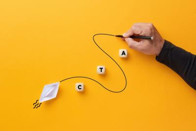 Male hand draws a curved line that guides a paper boat with the abbreviation CTA
