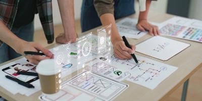 Close up ux developer and ui designer brainstorming interface wireframe design. Creative digital development agency