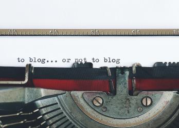 Vintage typewriter types out "to blog...or not to blog..."