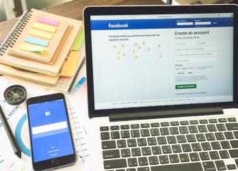 Laptop and smart phone screen showing the Facebook login screens